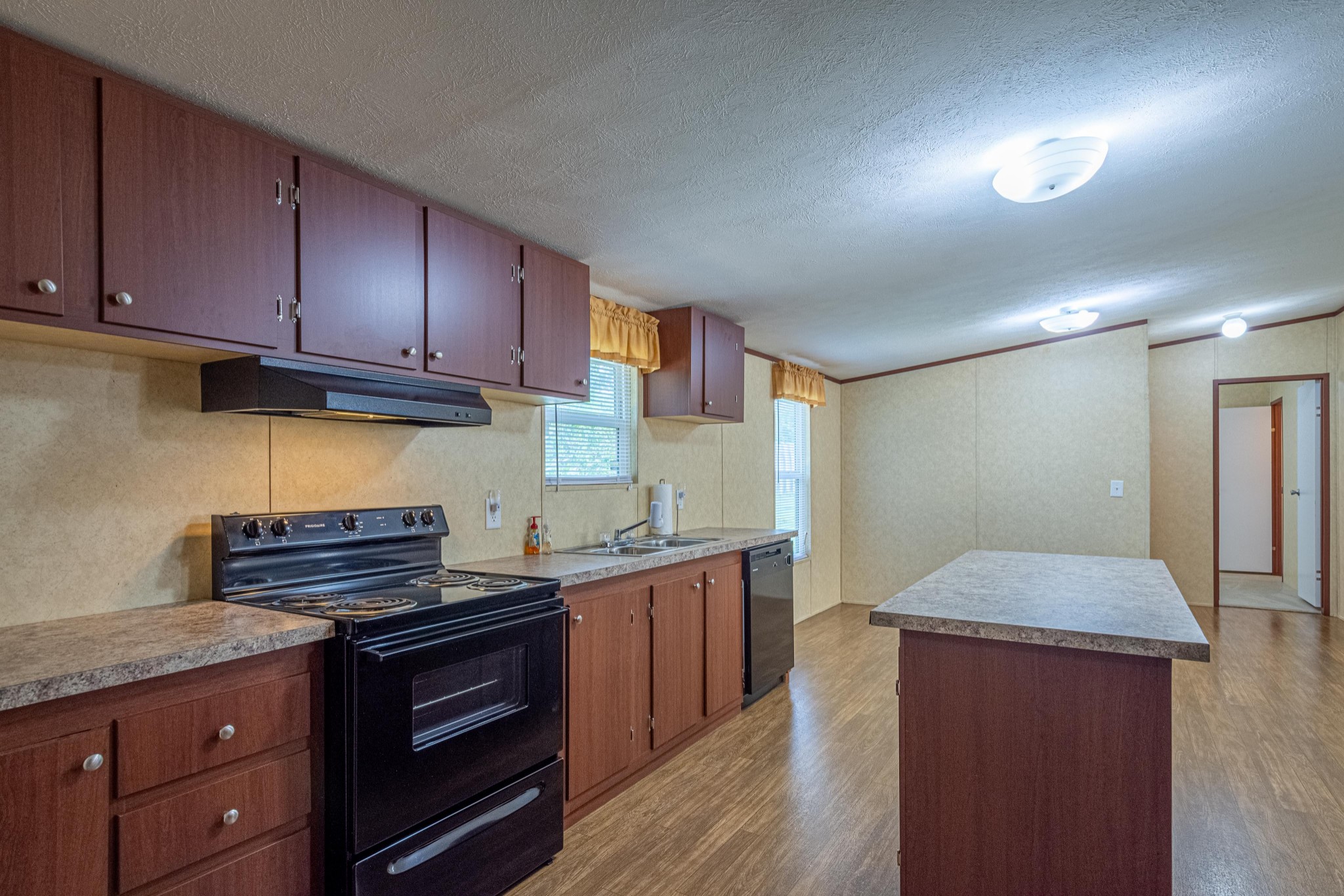 765 Crooked Hill Road Pulaski, TN 38478 - Photo 27 of 50 a kitchen with granite countertop wooden cabinets and a stove