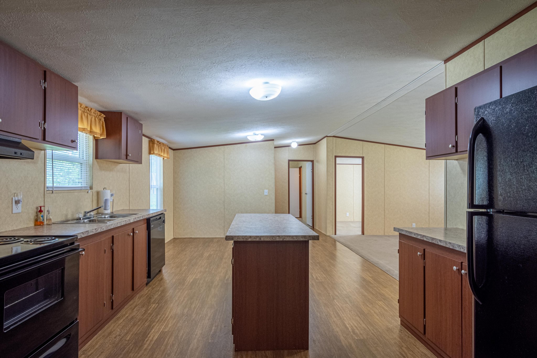 765 Crooked Hill Road Pulaski, TN 38478 - Photo 28 of 50 a kitchen with stainless steel appliances granite countertop a refrigerator a sink dishwasher and a stove with wooden floors