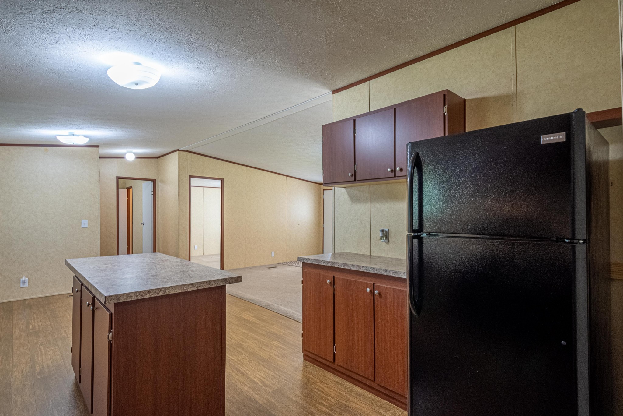 765 Crooked Hill Road Pulaski, TN 38478 - Photo 29 of 50 a kitchen with refrigerator and wooden cabinets