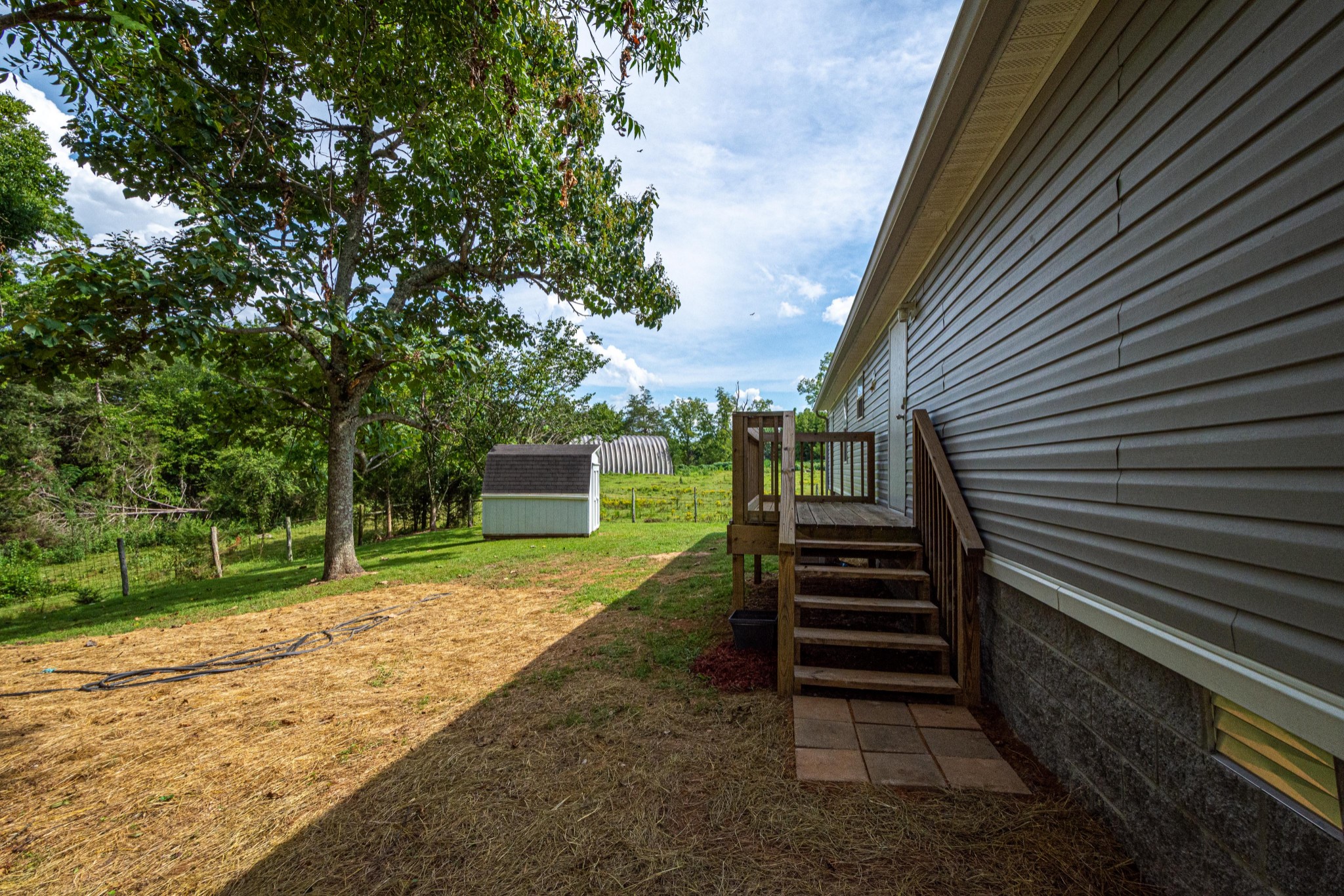 765 Crooked Hill Road Pulaski, TN 38478 - Photo 7 of 50 a view of a backyard with wooden fence and a large tree