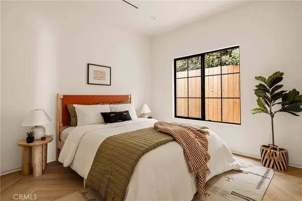 a bedroom with bed and a window