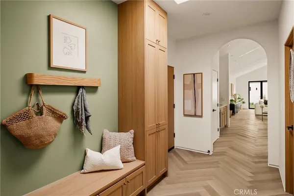 a view of entryway and hall with wooden floor