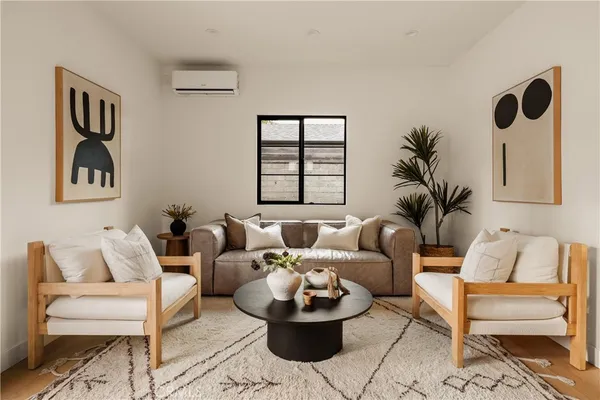 a living room with furniture and a potted plant