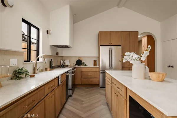 a kitchen with refrigerator and cabinets
