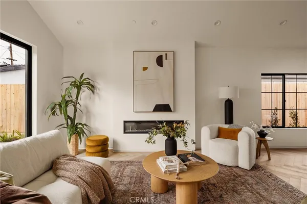 a living room with furniture and a potted plant