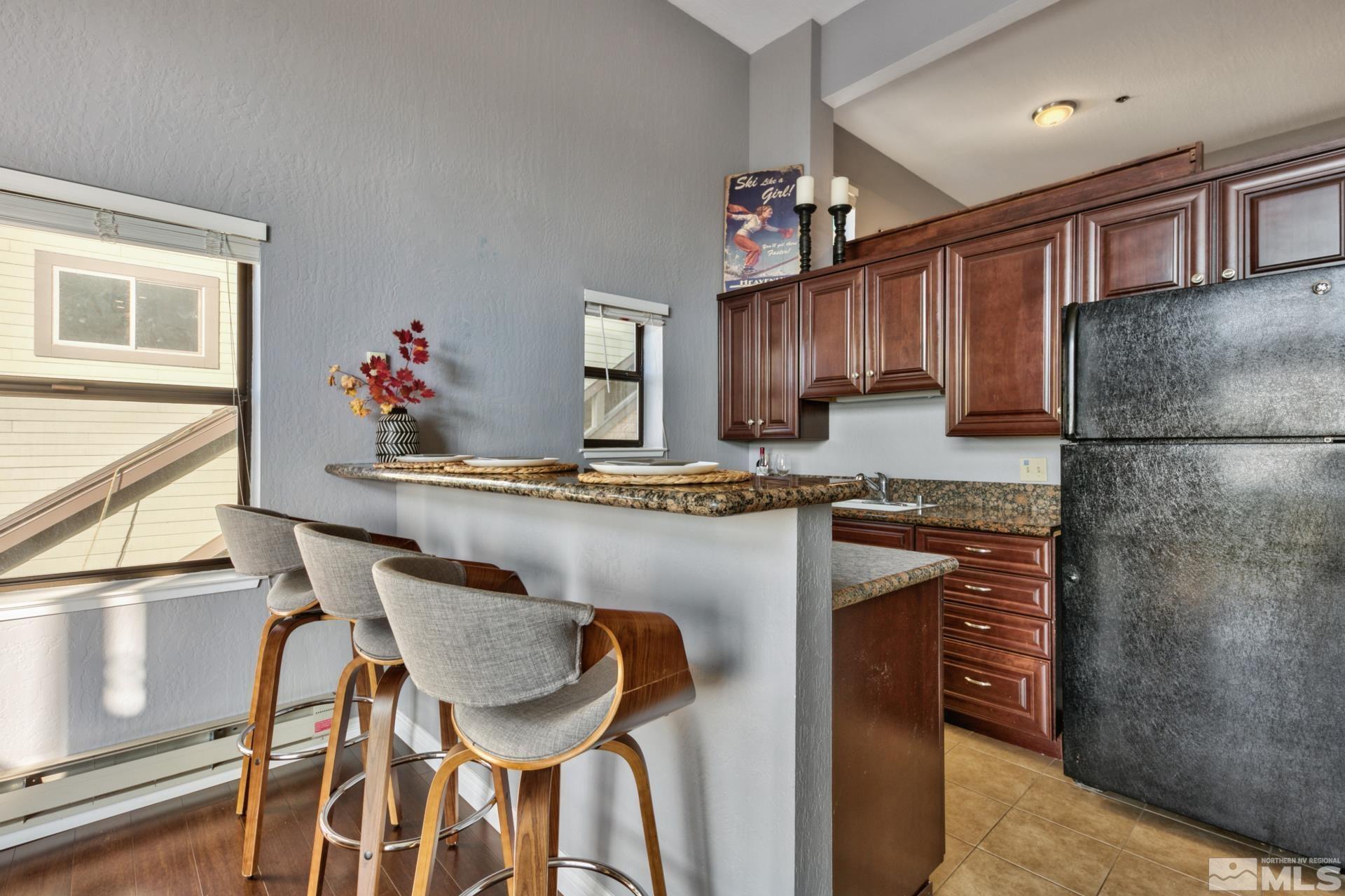 313 Tramway Drive, Unit 4 Stateline, NV 89449 - Photo 8 of 26 a kitchen with stainless steel appliances granite countertop a refrigerator and a stove top oven