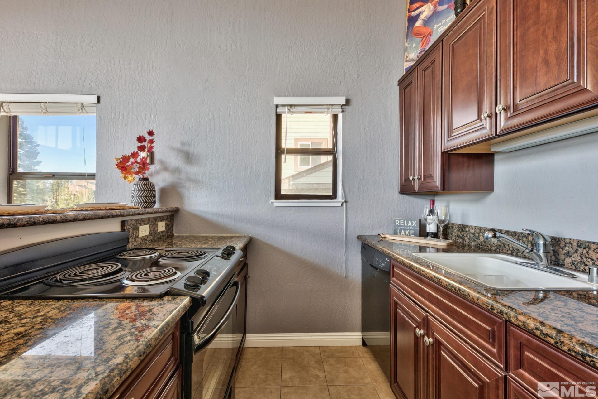313 Tramway Drive, Unit 4 Stateline, NV 89449 - Photo 9 of 26 a kitchen with stainless steel appliances granite countertop a sink stove and cabinets