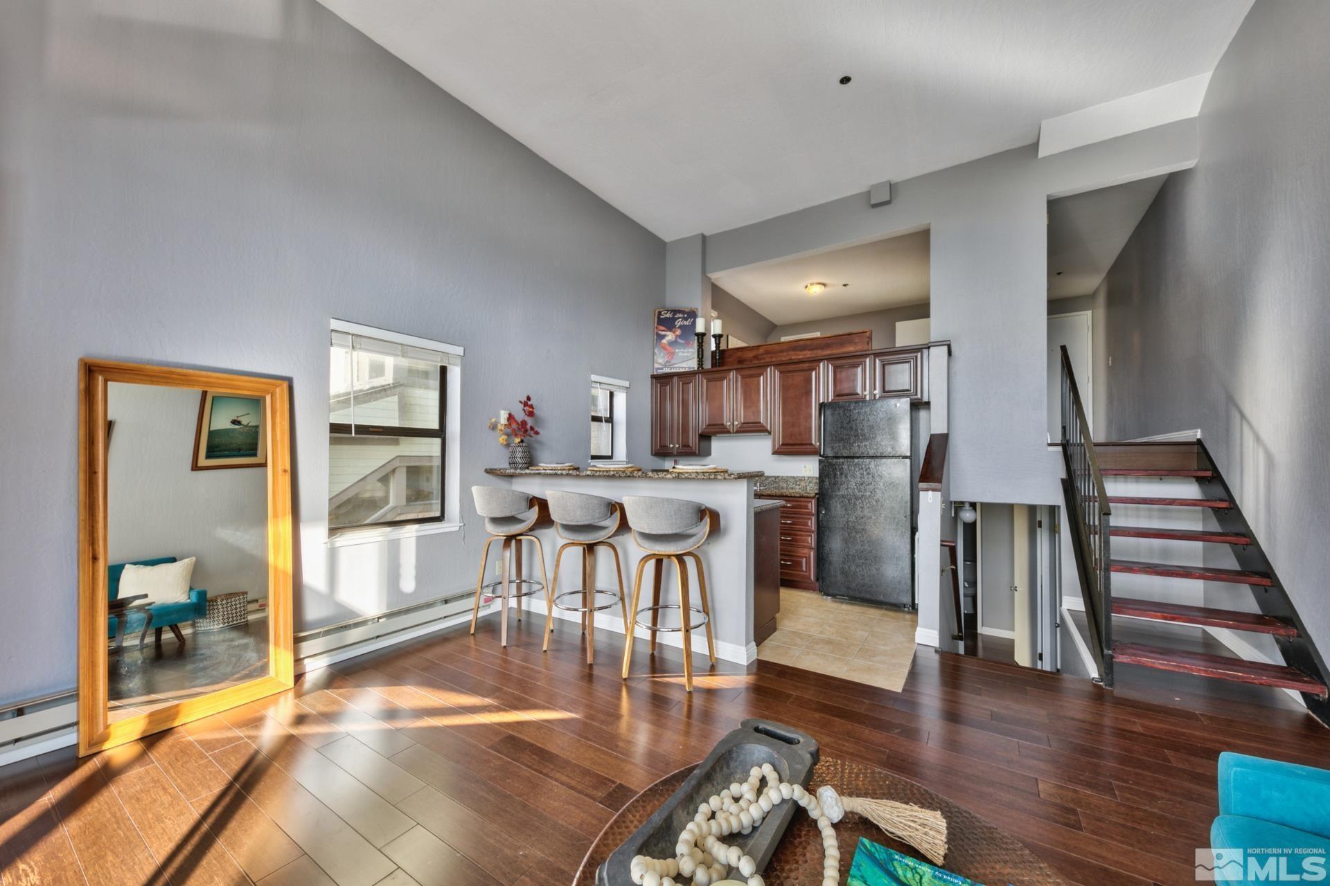 313 Tramway Drive, Unit 4 Stateline, NV 89449 - Photo 10 of 26 a living room with lots of wooden furniture and a dining table with wooden floor