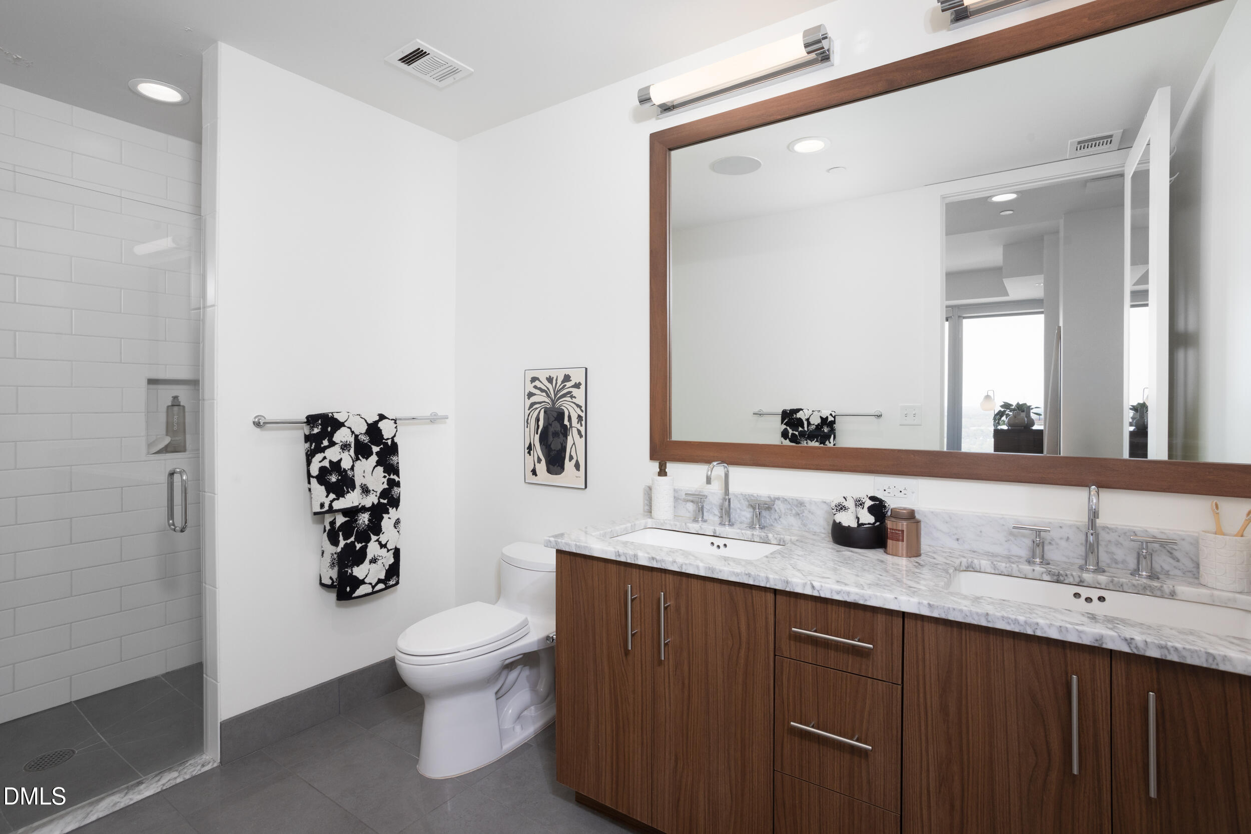 110 Corcoran Street, Unit 2603 Durham, NC 27701 - Photo 21 of 57 a bathroom with a granite countertop toilet sink and mirror