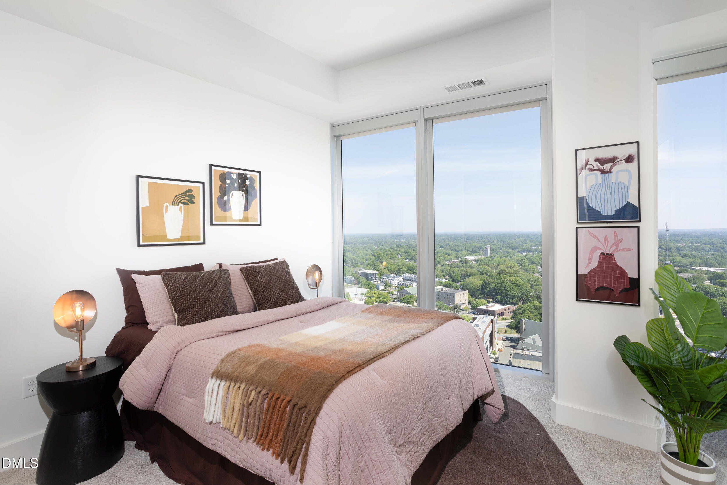 110 Corcoran Street, Unit 2603 Durham, NC 27701 - Photo 24 of 57 a bedroom with a bed and a painting on the wall
