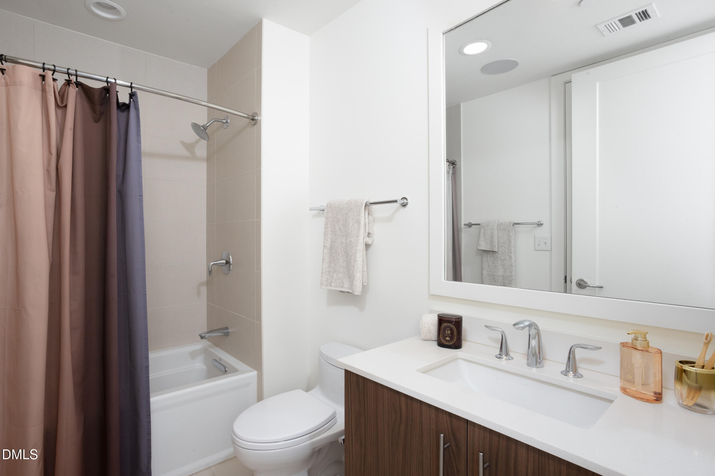 110 Corcoran Street, Unit 2603 Durham, NC 27701 - Photo 26 of 57 a bathroom with a double vanity sink toilet mirror and shower