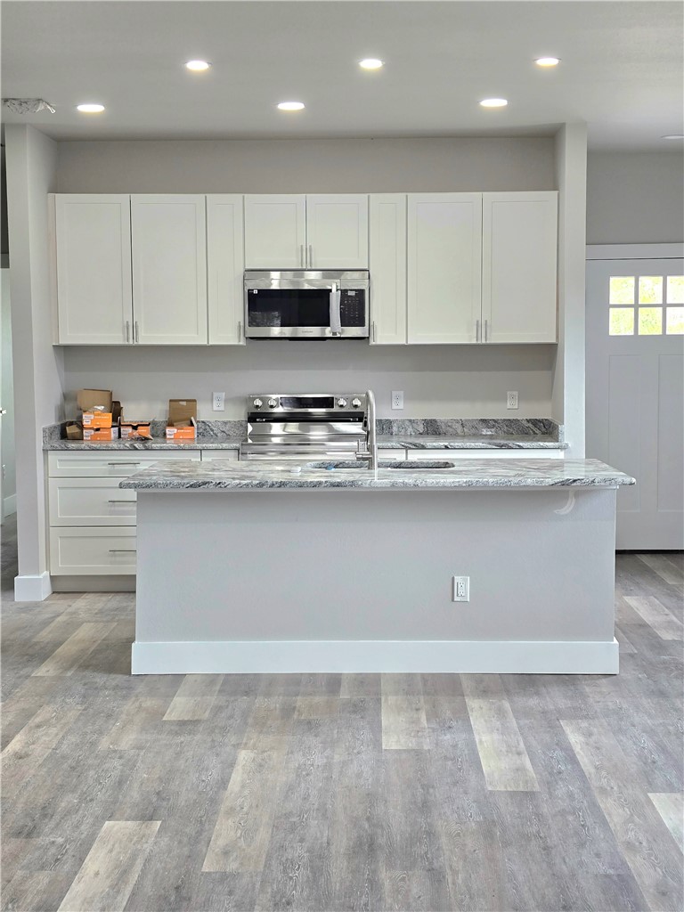 829 Utica Street Corpus Christi, TX 78418 - Photo 4 of 12 a view of kitchen with stainless steel appliances granite countertop white cabinets and sink