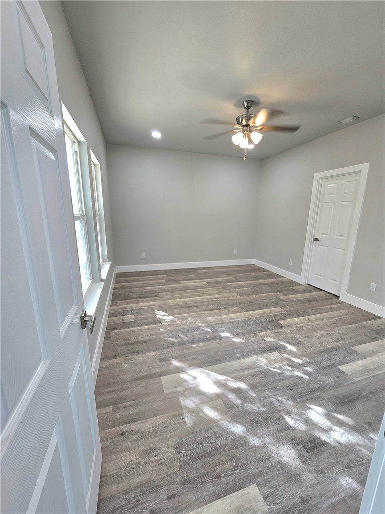 829 Utica Street Corpus Christi, TX 78418 - Photo 6 of 12 en empty room with windows and ceiling fan