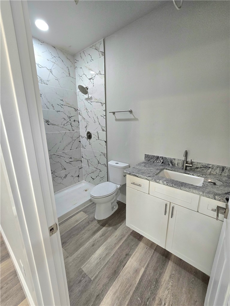 829 Utica Street Corpus Christi, TX 78418 - Photo 7 of 12 a bathroom with a granite countertop sink toilet and shower
