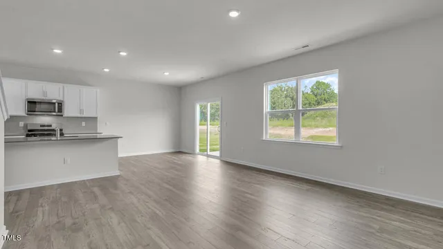 a view of kitchen with window and wooden floor