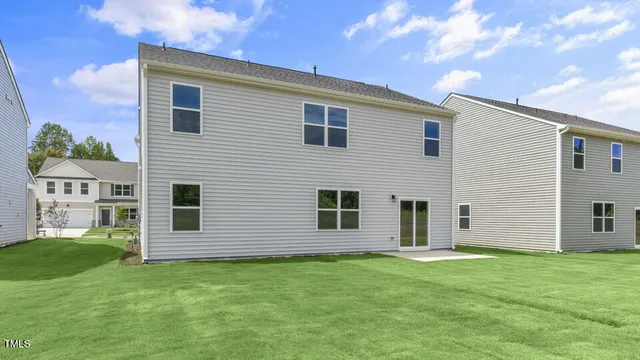 a view of a house with a backyard