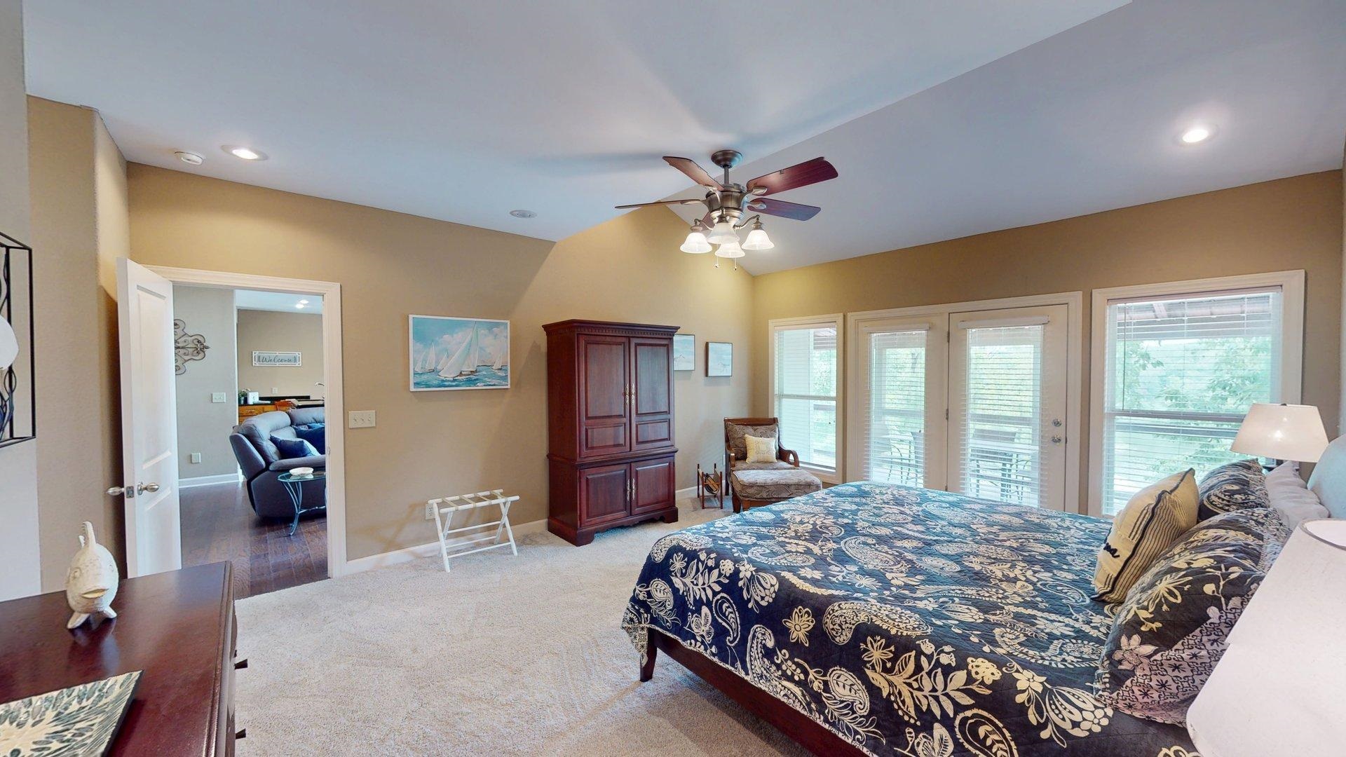 1085 Caney Hollow Road Counce, TN 38326 - Photo 12 of 39 a bedroom with a bed a chandelier and a large window
