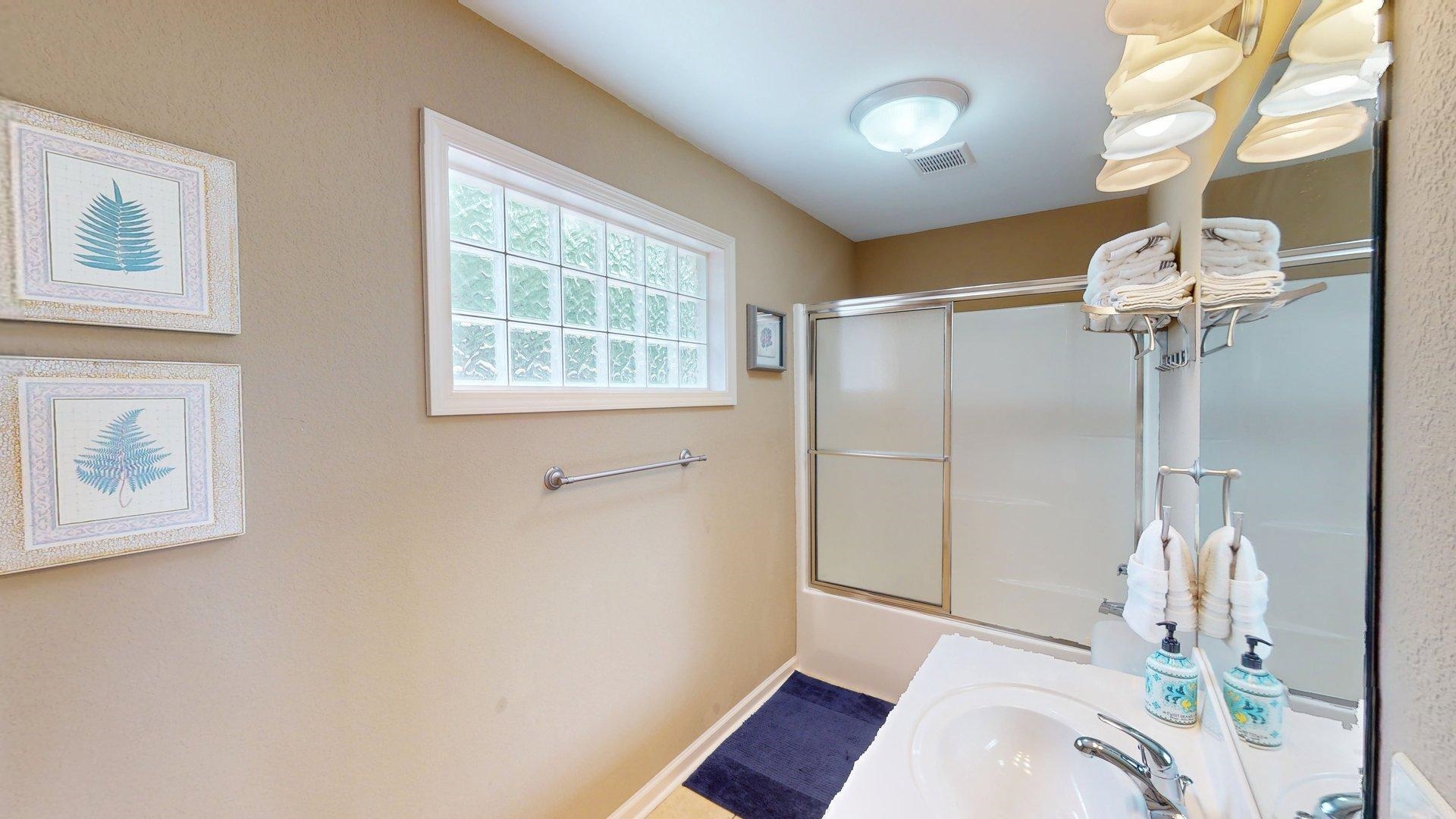 1085 Caney Hollow Road Counce, TN 38326 - Photo 28 of 39 Bathroom featuring enclosed tub / shower combo, baseboards, and a sink