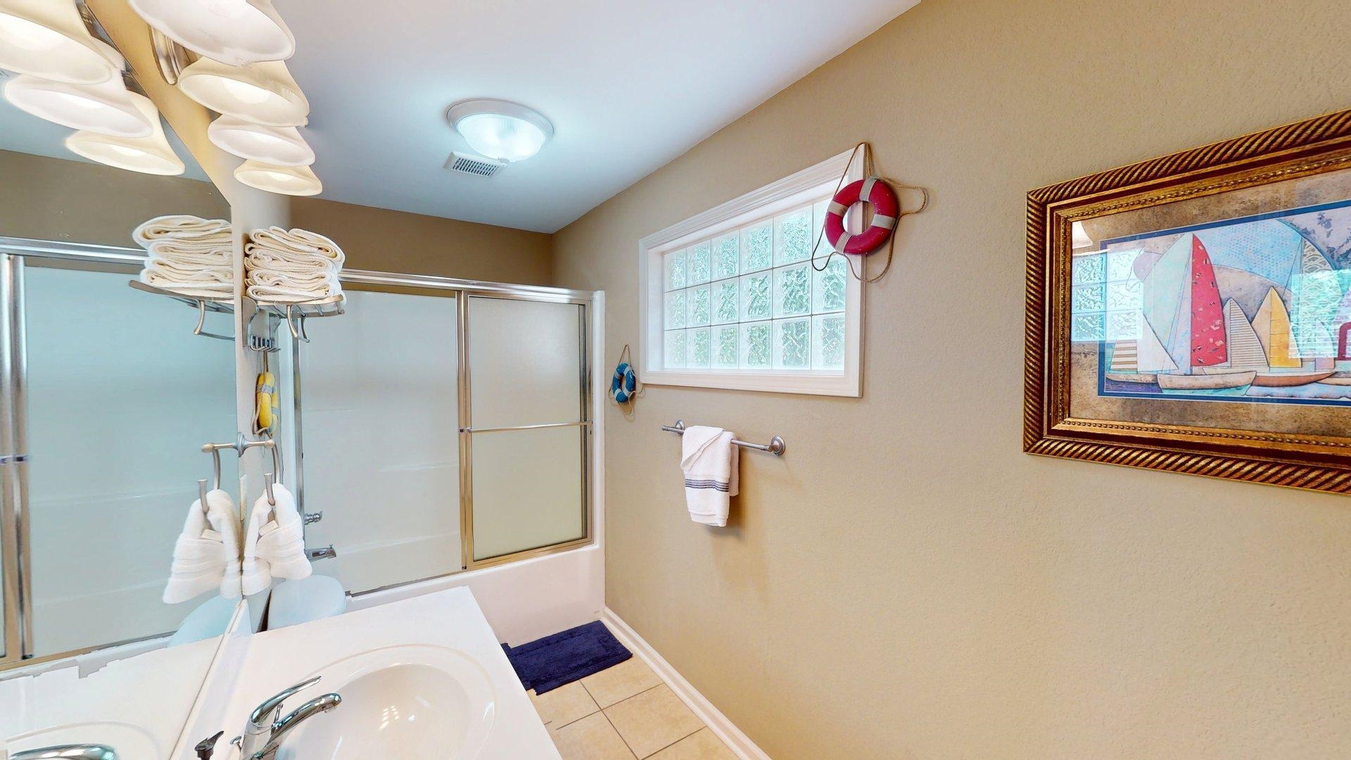 1085 Caney Hollow Road Counce, TN 38326 - Photo 30 of 39 Full bathroom with a sink, tile patterned floors, combined bath / shower with glass door, and baseboards