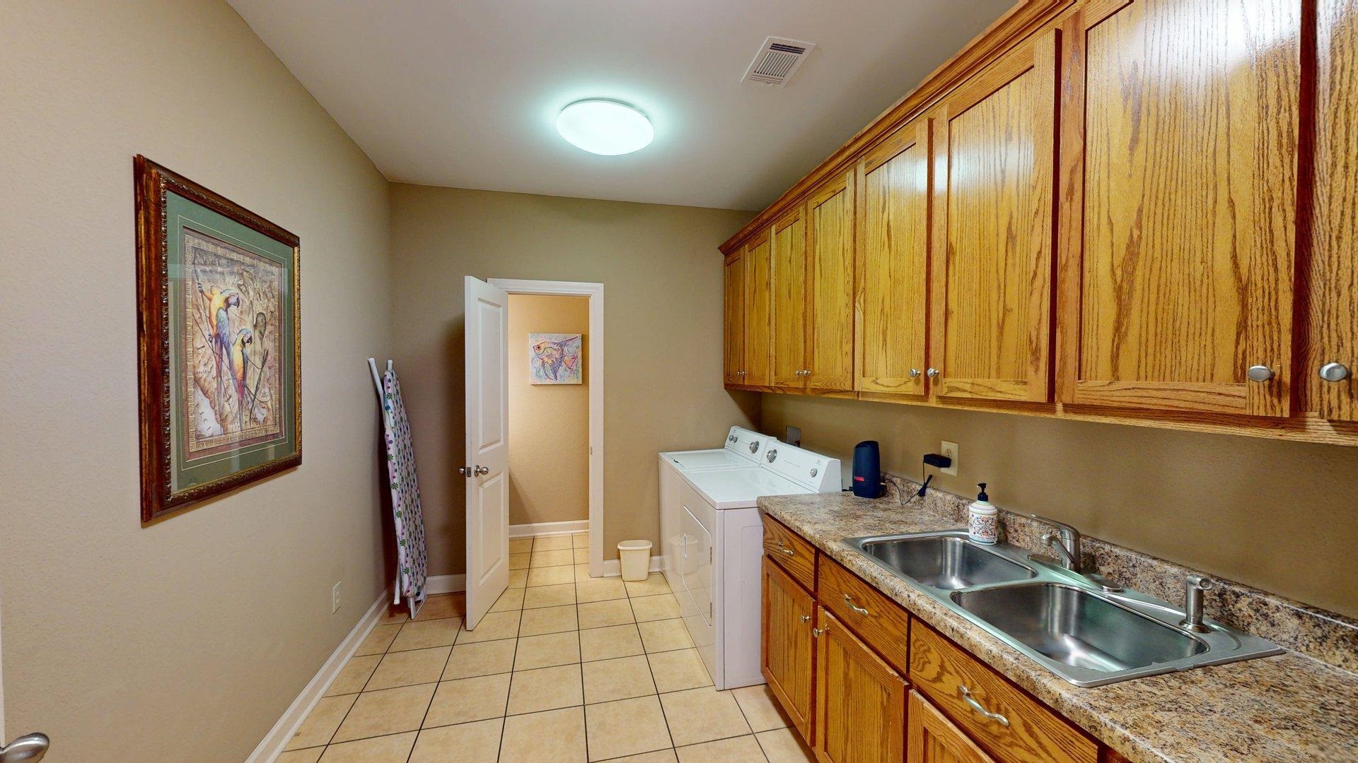 1085 Caney Hollow Road Counce, TN 38326 - Photo 32 of 39 Laundry area with cabinet space, washer and clothes dryer, light tile patterned floors, and baseboards