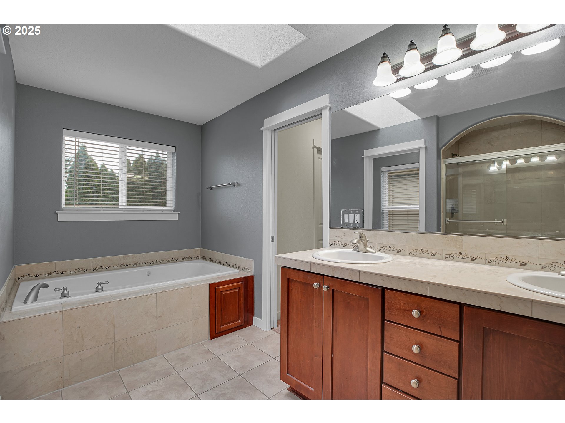 7110 Southwest Queen Lane Beaverton, OR 97008 - Photo 13 of 18 a bathroom with a tub sink and mirror
