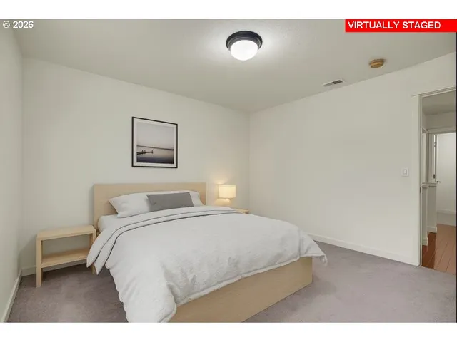 a bedroom with a bed and a night stand