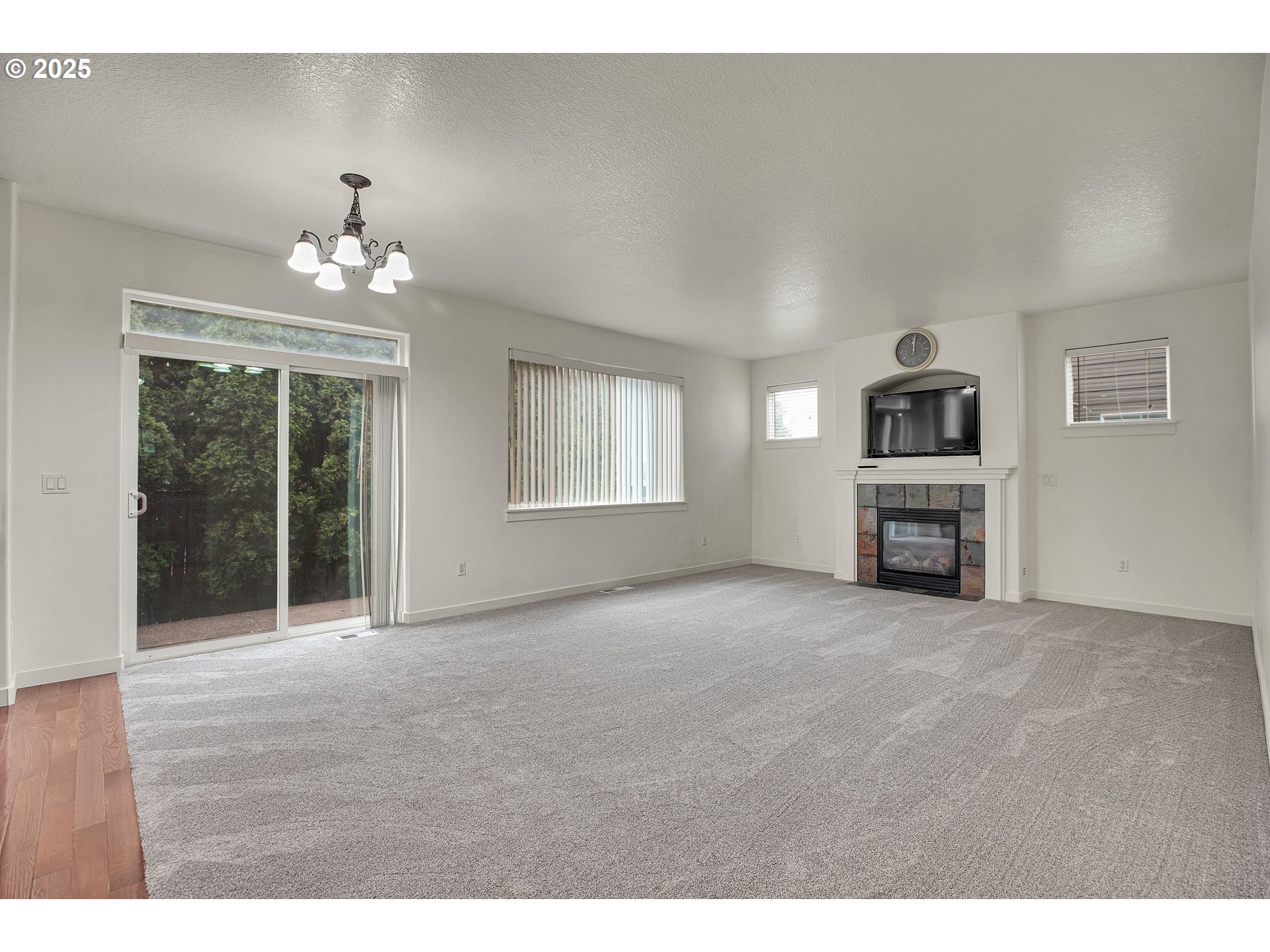 7110 Southwest Queen Lane Beaverton, OR 97008 - Photo 4 of 18 a view of an empty room with a fireplace and a window