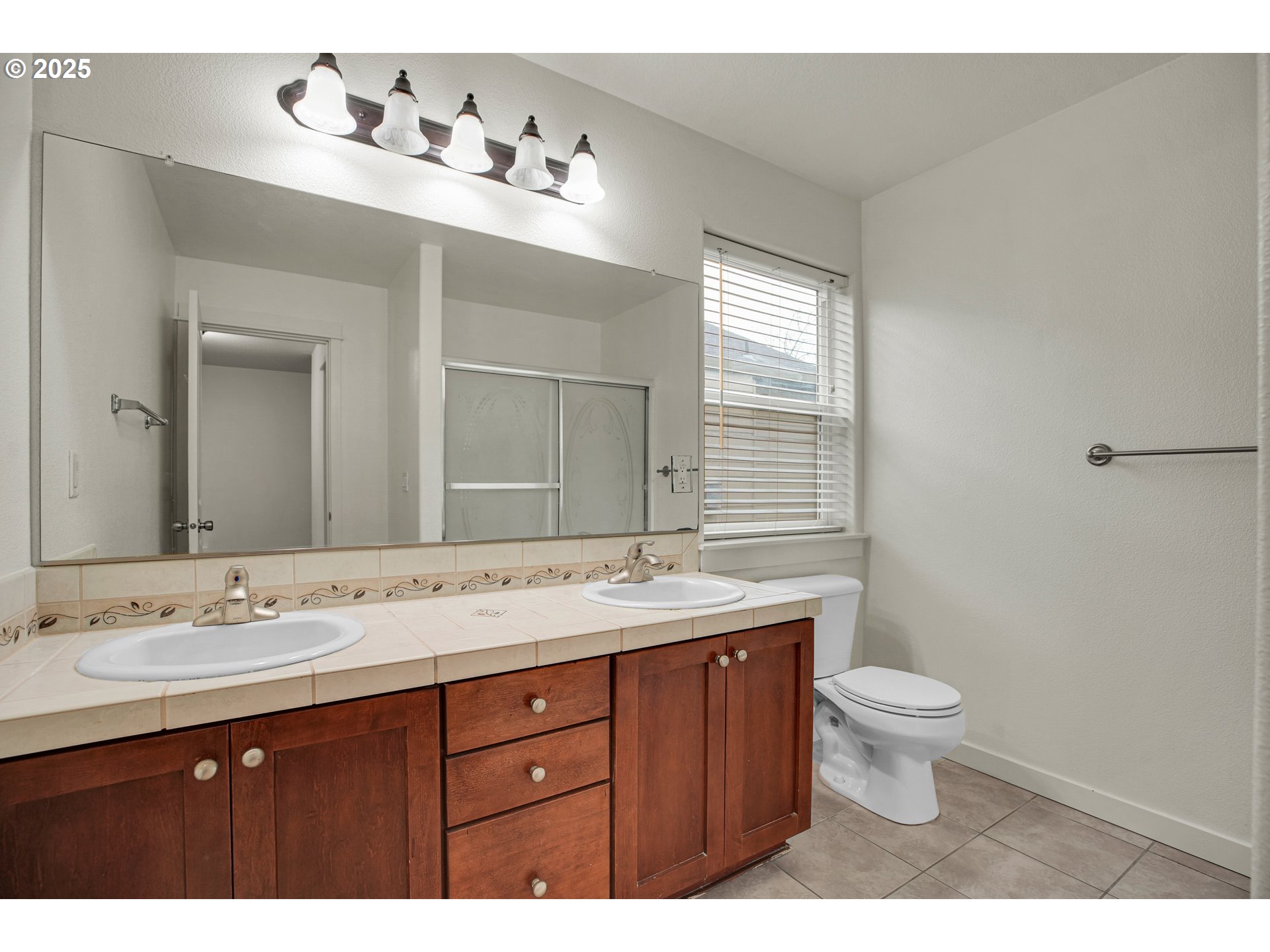 7110 Southwest Queen Lane Beaverton, OR 97008 - Photo 9 of 18 a bathroom with a granite countertop sink a toilet and a mirror