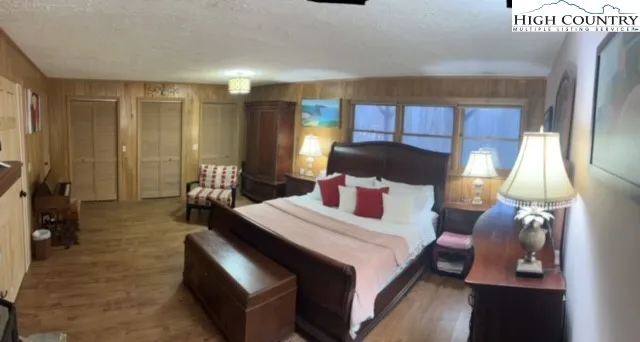 a bedroom with a bed a mirror and lamp