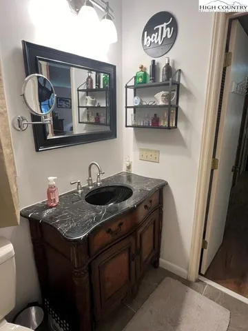 a bathroom with a granite countertop toilet sink and a shower