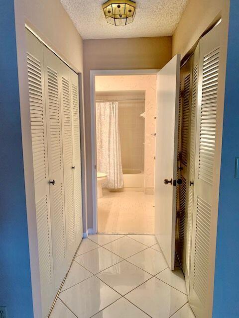 9095 Flynn Circle, Unit 6 Boca Raton, FL 33496 - Photo 12 of 19 a view of a hallway with wooden floor and a cabinet