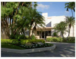 9095 Flynn Circle, Unit 6 Boca Raton, FL 33496 - Photo 15 of 19 a view of a white house with a yard and potted plants