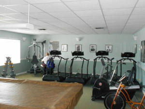 9095 Flynn Circle, Unit 6 Boca Raton, FL 33496 - Photo 16 of 19 a bed room with gym equipment and a mirror