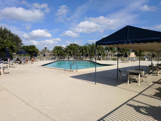 9095 Flynn Circle, Unit 6 Boca Raton, FL 33496 - Photo 17 of 19 a view of a swimming pool with a patio