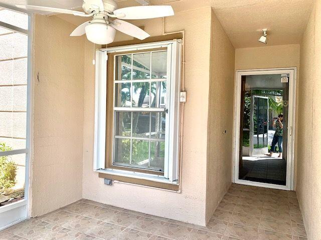 9095 Flynn Circle, Unit 6 Boca Raton, FL 33496 - Photo 2 of 19 an empty room that has a window and kitchen view