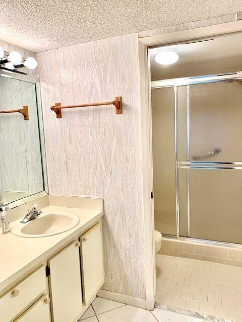 9095 Flynn Circle, Unit 6 Boca Raton, FL 33496 - Photo 10 of 19 a bathroom with a sink and a mirror