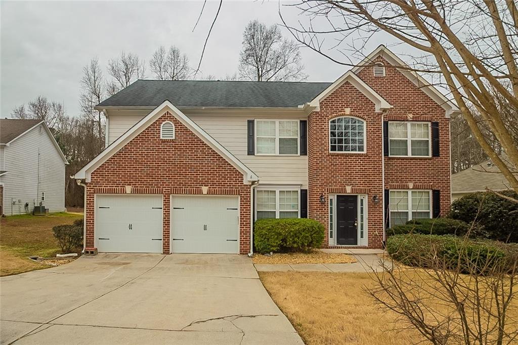 559 Serene Waters Trail Stockbridge, GA 30236 - Photo 1 of 1 a front view of a house with a yard and garage