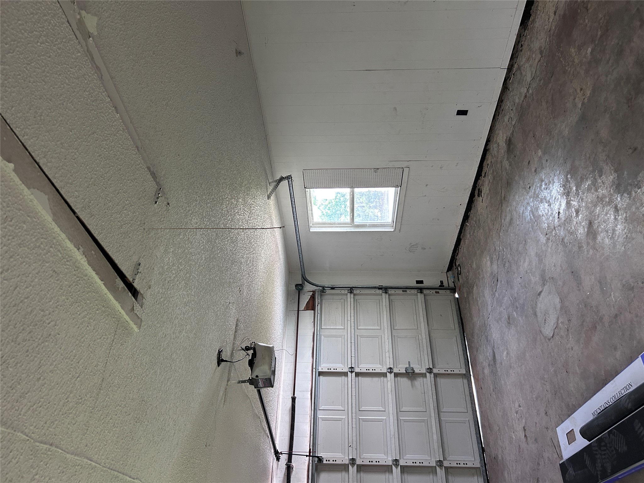 6603 Ripple Run Austin, TX 78744 - Photo 16 of 16 A utilitarian space featuring a concrete floor and functional overhead door, ideal for storage or vehicle accommodation.