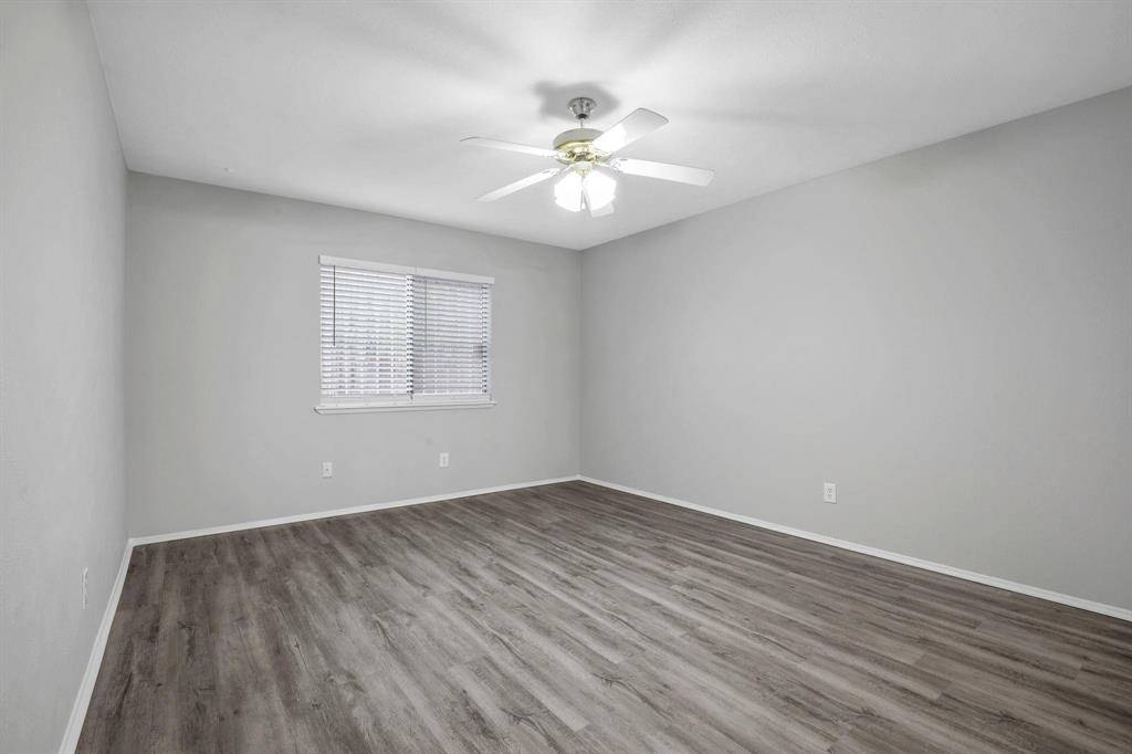 7129 Sorcey Road Dallas, TX 75249 - Photo 14 of 17 Unfurnished room with wood finished floors and ceiling fan