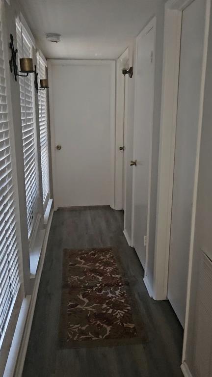 7129 Sorcey Road Dallas, TX 75249 - Photo 16 of 17 Corridor with dark wood-style flooring