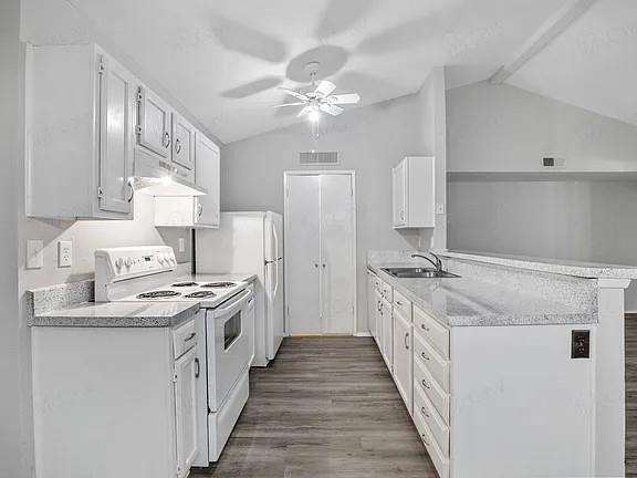7129 Sorcey Road Dallas, TX 75249 - Photo 6 of 17 Kitchen with white appliances, white cabinetry, a peninsula, light wood finished floors, and under cabinet range hood