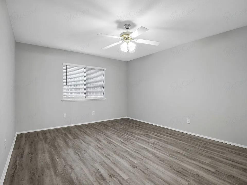 7129 Sorcey Road Dallas, TX 75249 - Photo 9 of 17 Unfurnished room with wood finished floors and ceiling fan