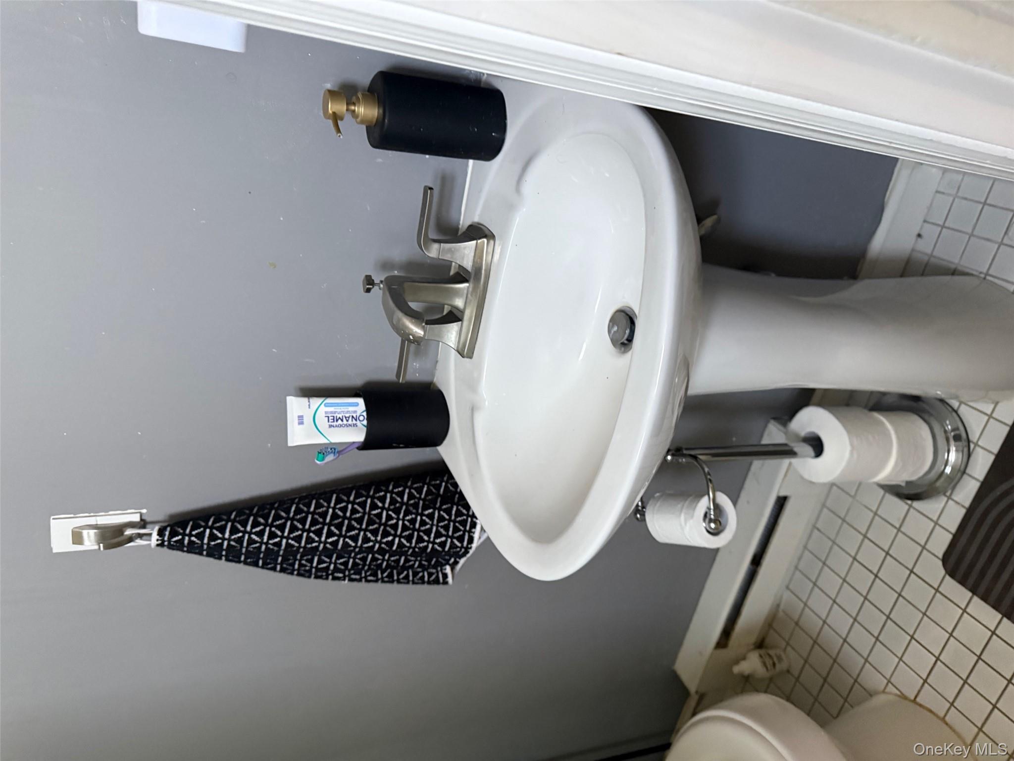 93 Jackson Avenue, Unit 1 Nyack, NY 10960 - Photo 9 of 10 Bathroom featuring baseboard heating and light tile patterned flooring