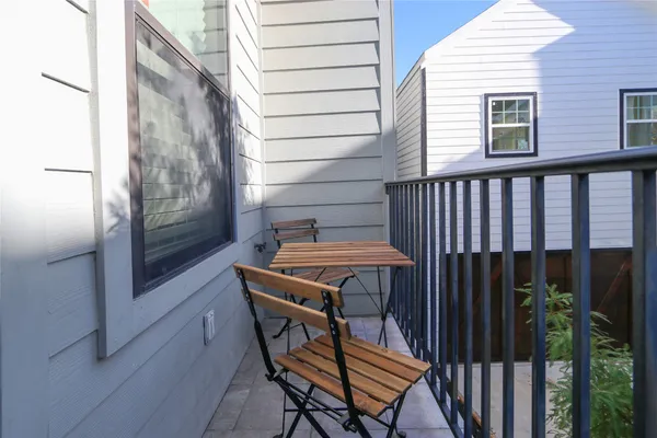 a backyard of a house with barbeque oven and outdoor seating