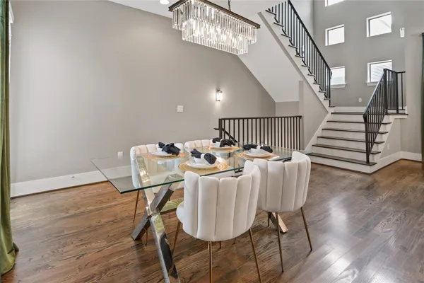 a view of a dining room with furniture wooden floor and chandelier