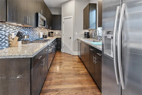 a large kitchen with a granite counter tops and a sink