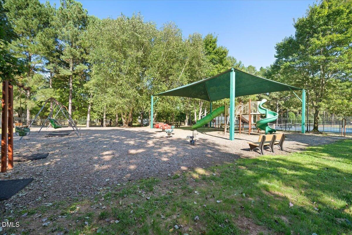 324 Waterville Street Raleigh, NC 27603 - Photo 11 of 82 a view of a park with a bench and some trees