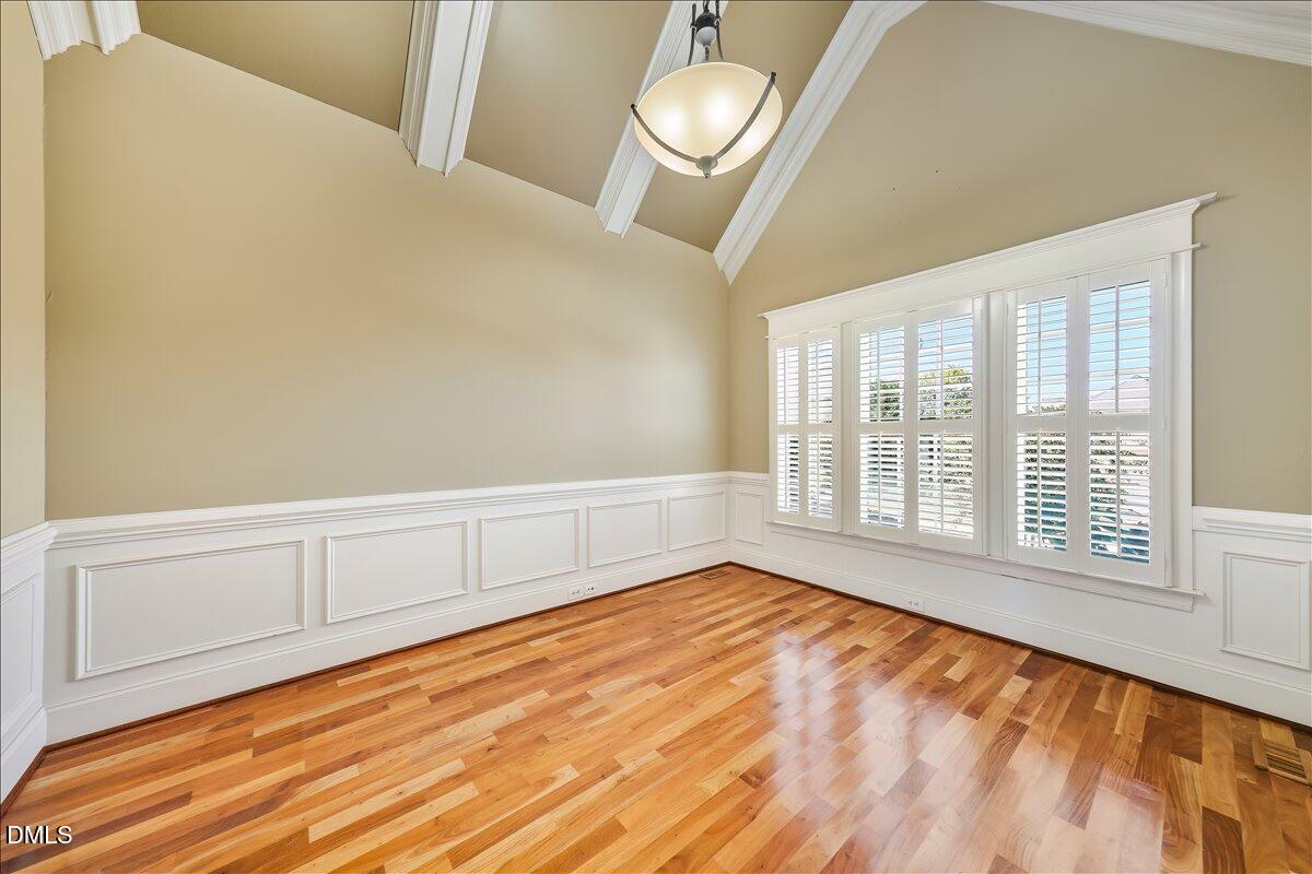324 Waterville Street Raleigh, NC 27603 - Photo 24 of 82 a view of an empty room with a window and wooden floor