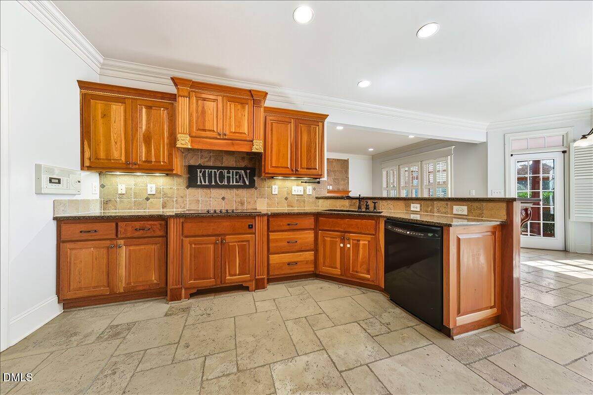 324 Waterville Street Raleigh, NC 27603 - Photo 26 of 82 a kitchen with stainless steel appliances granite countertop a stove sink and cabinets