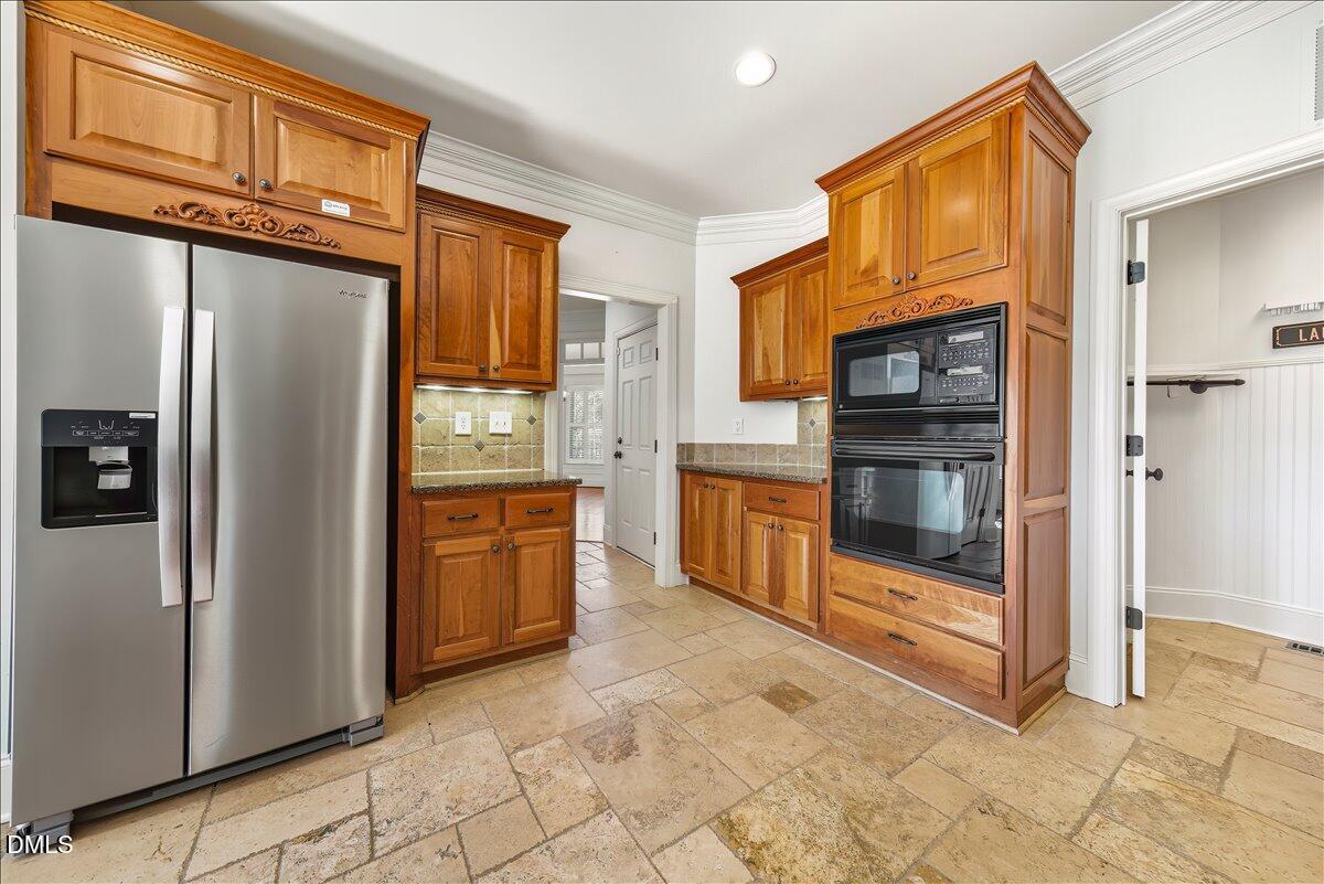 324 Waterville Street Raleigh, NC 27603 - Photo 27 of 82 a kitchen with stainless steel appliances granite countertop a refrigerator and a sink